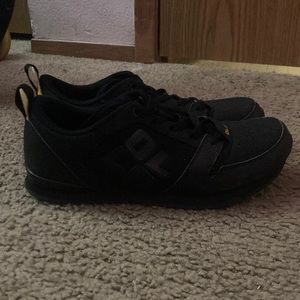 Black and yellow pair of OLLOs. They are shoes meant for activity’s like running